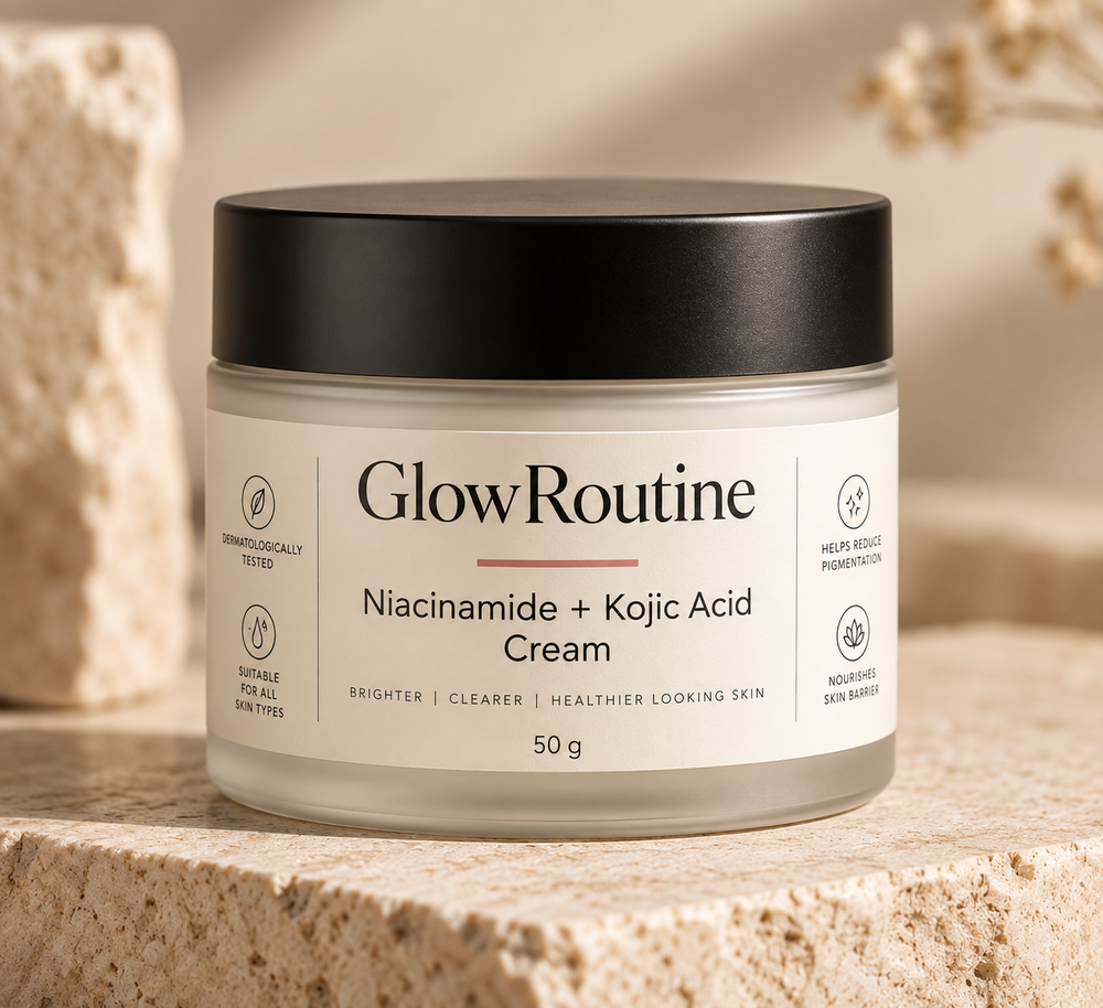 GlowRoutine Niacinamide + Kojic Acid Cream product packaging on a warm stone surface